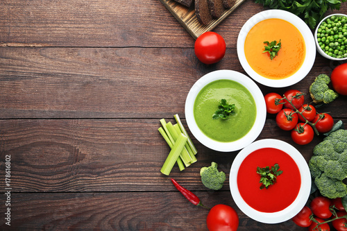 Vegetable cream soup with parsley on wooden table