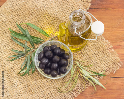 Black olives, olive oil and olive branches