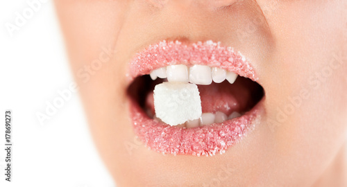 Sweet woman lips with granulated sugar