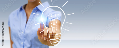 Businesswoman touching a sketch lightbulb