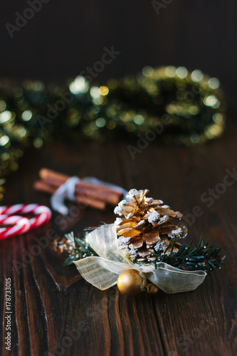 Christmas decoration with pinecone on wooden board.
