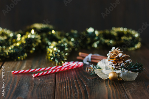 Christmas decoration with pinecone on wooden board.