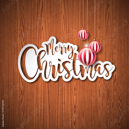 Merry Christmas Hand Lettering Illustration with Paper Label and Red Ornamental Glass Balls on Vintage Wood Background. Vector EPS 10 Holiday Design.