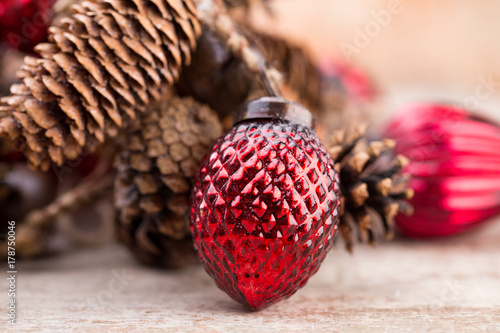 Christmas cone with red berries on a bokeh background.