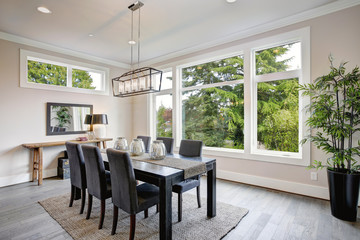 Luxurious modern dining room boasts a black dining table