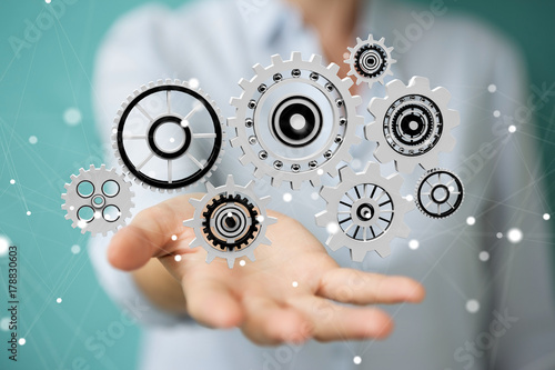 Businesswoman using floating gear icons 3D rendering