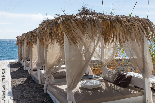 Relaxation zone on the black beach between the villages of Perissa and Perivolos in Santorini