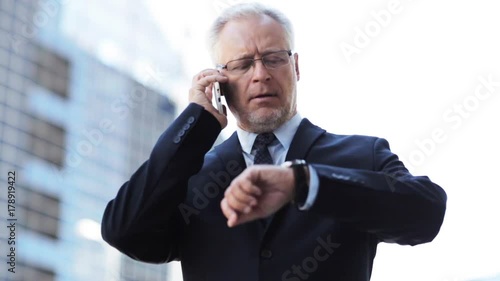 senior businessman calling on smartphone in city