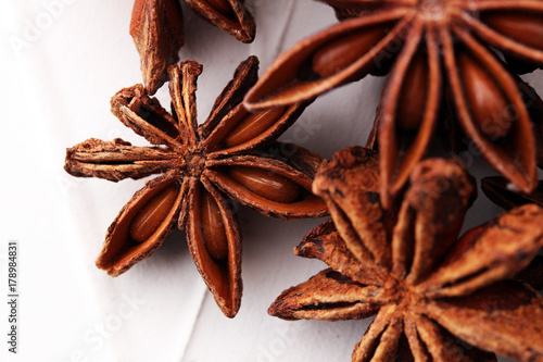 Anise star seeds on the wooden background. Aromatic ingredient in culinary