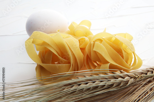 traditional italian homemade pasta with ingredients on white background.