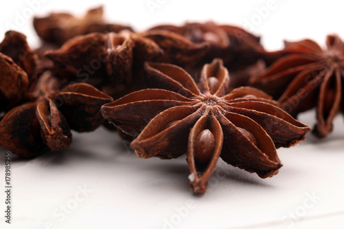 Anise star seeds on the wooden background. Aromatic ingredient in culinary
