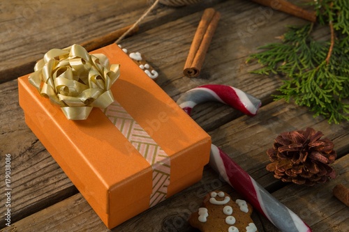 Close up of gift box by candy cane and spice