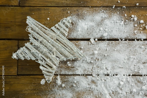 Overhead view of star shape decoration amidst artificial snow