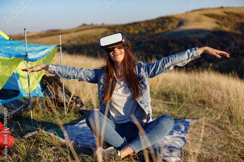 Young woman have fun with  VR Headset BOX at camping