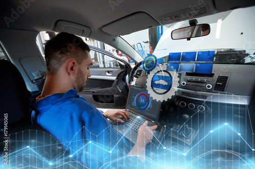 mechanic man with laptop making car diagnostic