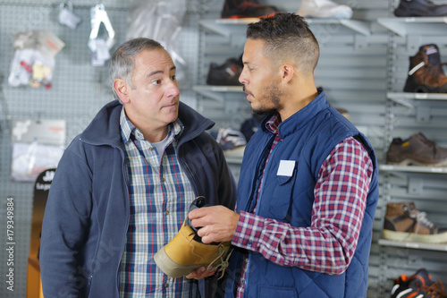 male selling working shoes to mature man