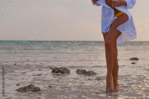 Woman on beach at sunset
