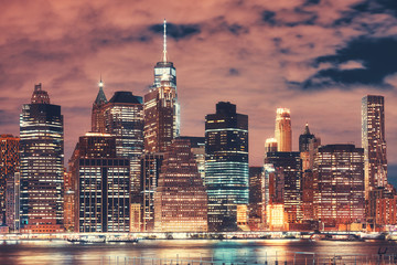New York City skyline at night, color toned picture, USA.