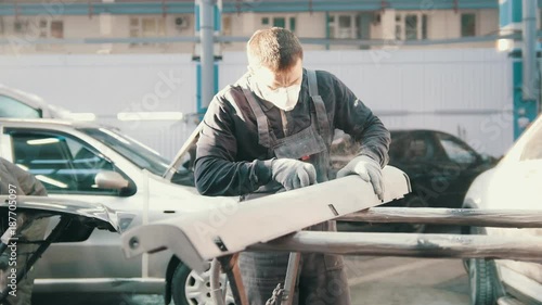 Видео: Man worker in automobile service - manual labor - polishes car, close up Man worker in automobile service - manual labor - polishes car, close up