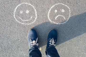 Happy Smileys or Unhappy, text on asphalt road