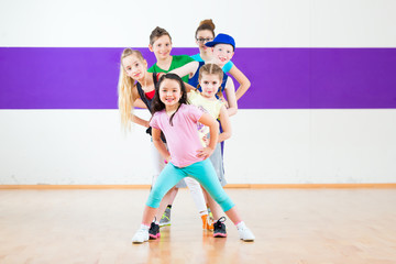 Children in zumba class dancing modern group choreography 