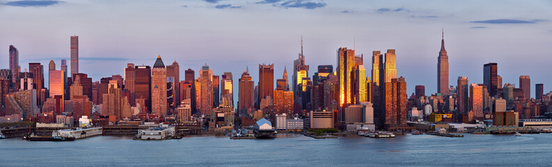 Panoramic view, skyscrapers of Midtown Manhattan at sunset with the Hudson River. New York City