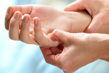 Therapist manipulating sensitive area on hand.