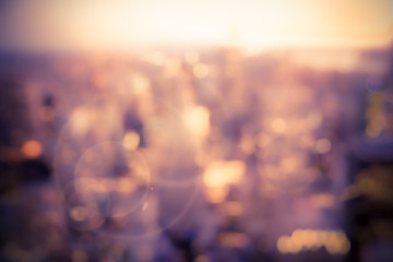 Defocused blur of buildings across New York City with sunflare effect