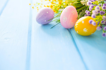 Colorful easter decorations on wooden plank