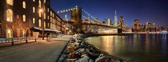 Brooklyn Bridge Park waterfront in evening with view of skyscrapers of Lower Manhattan and the Brooklyn Bridge. Brooklyn, Manhattan, New York City