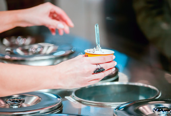 Woman behind counter serving ice cream