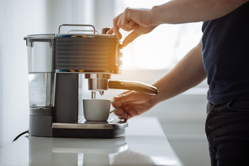 A man prepares espresso for a coffee maker