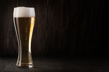 Glass beer on wood background