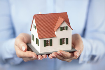 woman holding house in her hands