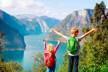 happy little boy and girl travel in nature, family hiking