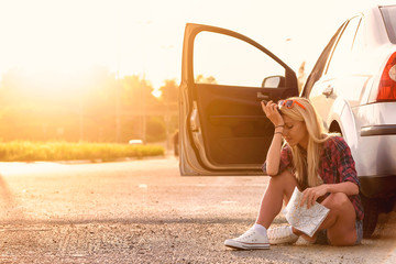 Beautiful young woman traveler lost on highway
