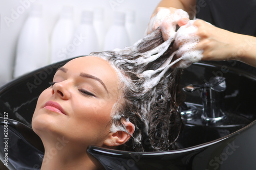 Hairdresser washing woman's hair in hairdresser salon © tcsaba