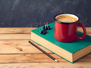 Coffee cup and old book
