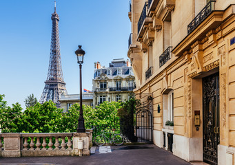 Cozy street with view of Paris Eiffel Tower in Paris, France. Eiffel Tower is one of the most iconic landmarks in Paris.