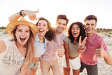 Group of happy young friends in summer clothes