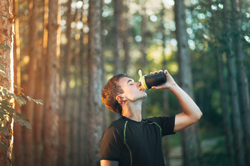 Runner Drinking Water in Park