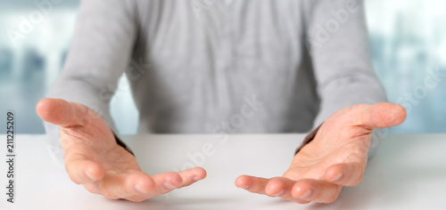 Фото: Empty holding hands of a young relaxed man over a desk Empty holding hands of a young relaxed man over a desk