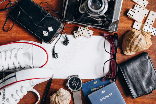 Фото: Overhead view of Traveler's accessories, Essential vacation items, Travel concept background. Different objects on wooden background. Overhead view of Traveler's accessories, Essential vacation items, Travel concept background. Different objects on wooden background.