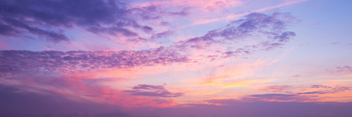 Panoramic view of a pink and purple sky at sunset