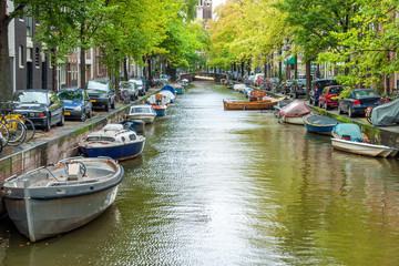 Typical houseboats along the canal in downtown Amsterdam