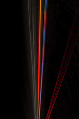 Interesting and abstract rays of light in orange and purple that can be used as background or texture