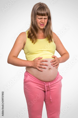 Foto obraz na płótnie canvas czteroczęściowy - "tetraptyk" - Pregnant woman with stomach ache - heartburn concept