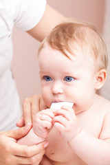 Little baby receiving osteopathic treatment of her arm