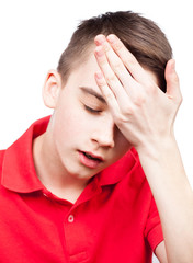 Teen boy with headache isolated on white