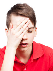 Teen boy with headache isolated on white